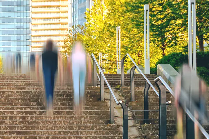 Public stairway with handrails and blurred pedestrians, slip and fall risks in NYC
