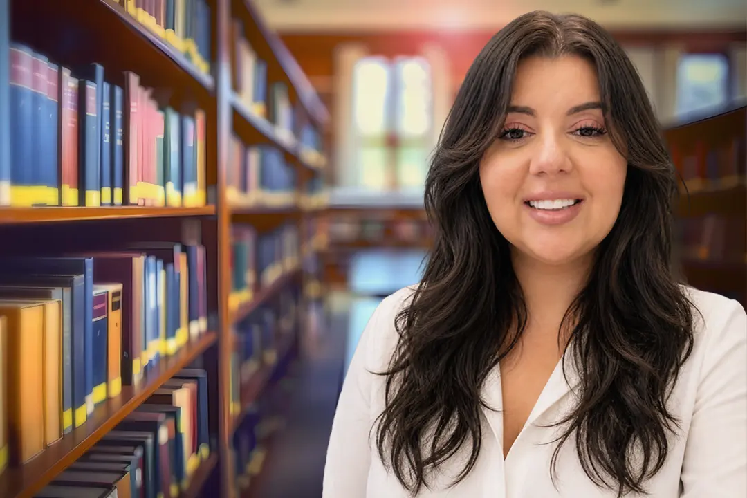 Johanna Torres-Comas, office manager and calendar clerk, pictured in a law library setting