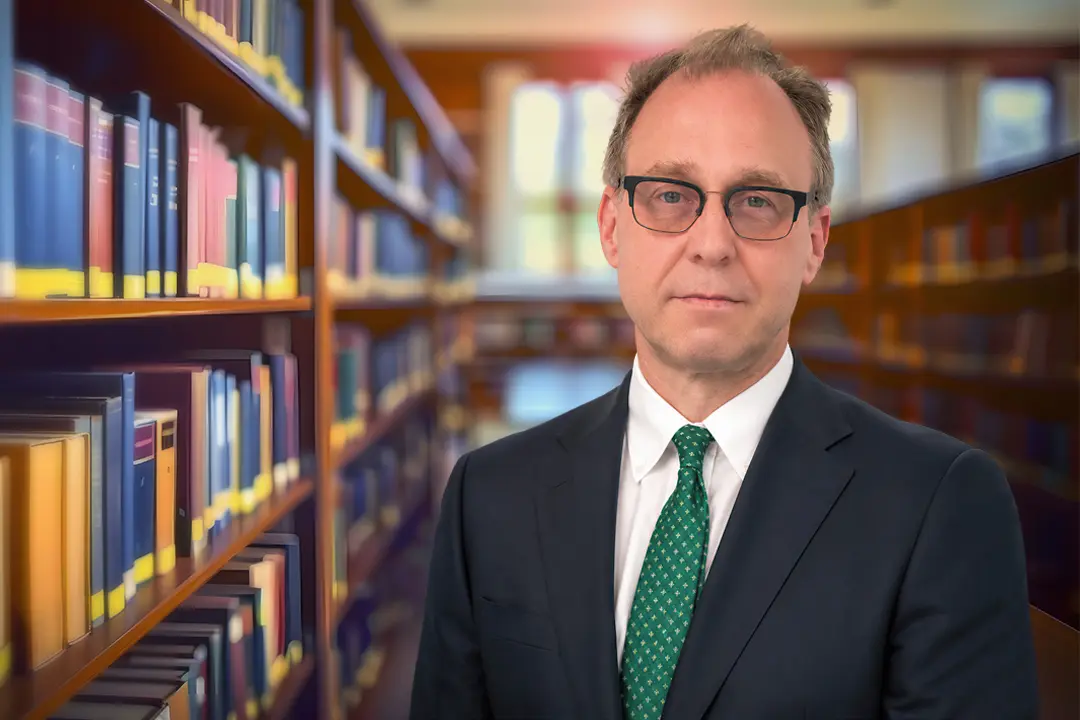 J.P. Delaney, personal injury lawyer, pictured in a law library setting